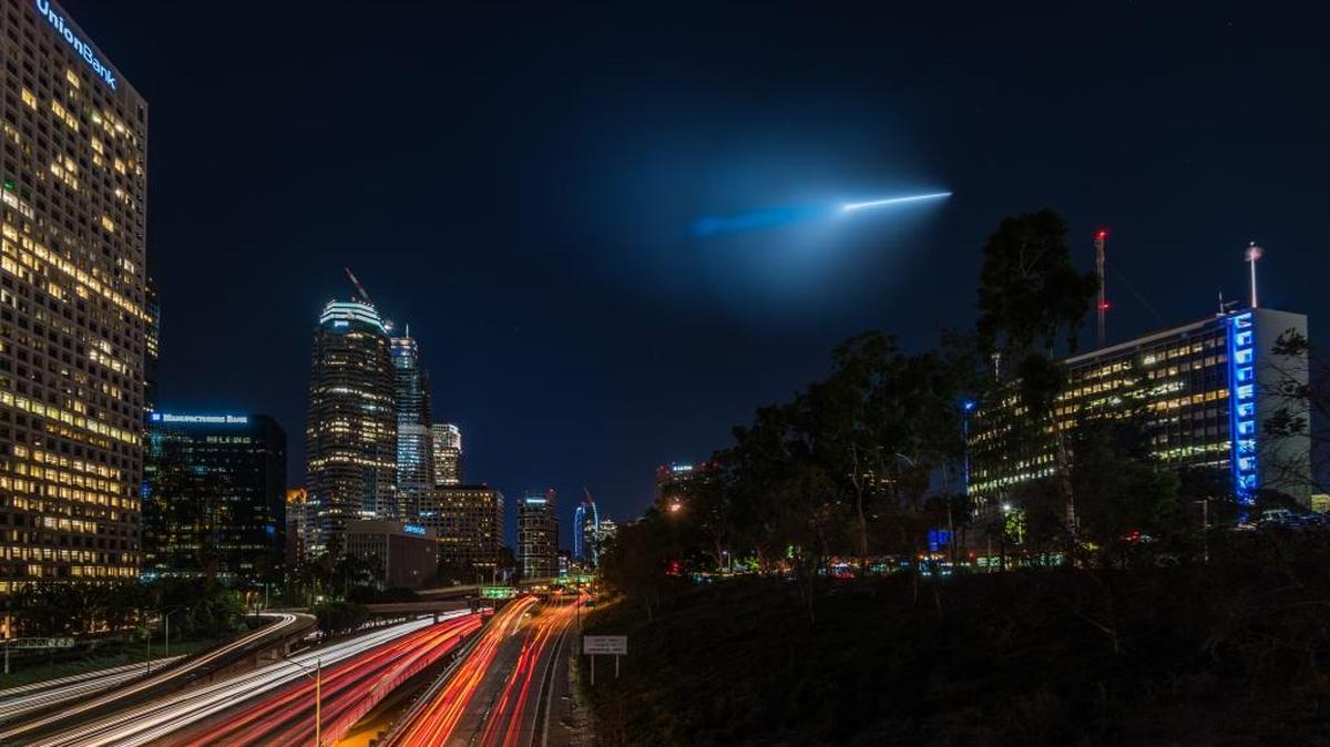 A flying object soars over downtown Los Angeles on Saturday night as seen from the Fourth Street Street Bridge over Highway 110.