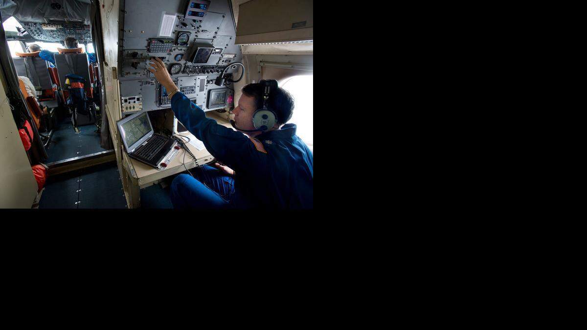 
Crew member Peter Siegel collects scientific data on a mission over the Pacific Ocean and the Northern California coast on Thursday. The NOAA  P3 “Hurricane Hunter” deployed dozens of bathythermograph  devices into the ocean, and used onboard atmospheric sensors to gather data about the atmospheric river weather system approaching California.
