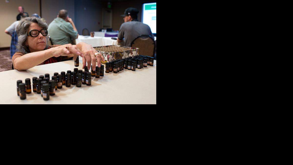 
Jacie Ann Crowell of Arizona displays some of the oils that can be infused with cannabis during a workshop for potential business owners of the industry in Sacramento on Sunday. California anticipates a 2016 ballot initiative to legalize marijuana for recreational use, and seminars for potential marijuana businesses are being held.
