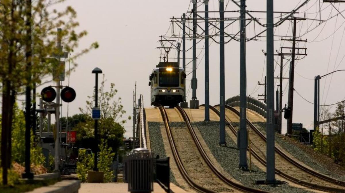 A light rail train crosses over Sunrise Boulevard from Folsom.