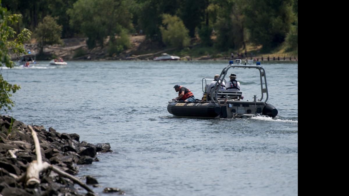 
Members of the Drowning Accident Rescue Team of the Sacramento County Sheriff’s Department look for the body of a 24-year-old man who drowned south of the confluence of the Sacramento and American rivers on Sunday.

