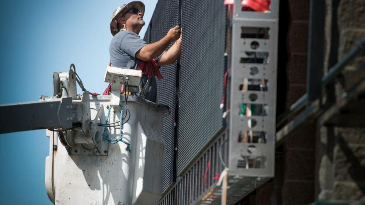 Jorge Diaz of Impact Sign works Thursday on a new LED video board that will stretch 120 feet wide above Raley Field’s left field wall. The board is the handiwork of D3 LED, a Rancho Cordova company.