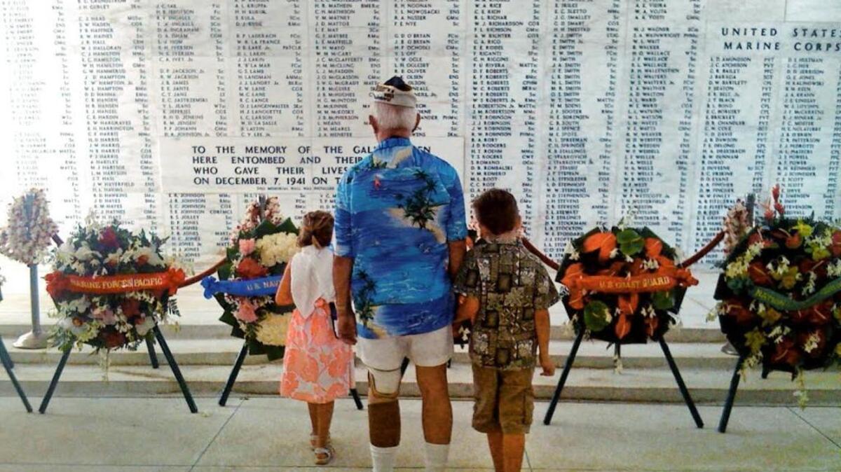 Bob Addobati, center, visits the USS Arizona memorial with two of his grandchildren, Meghan Kanotz, left, and Jack Kanotz at Pearl Harbor, Hawaii, on Dec. 7, 2010.