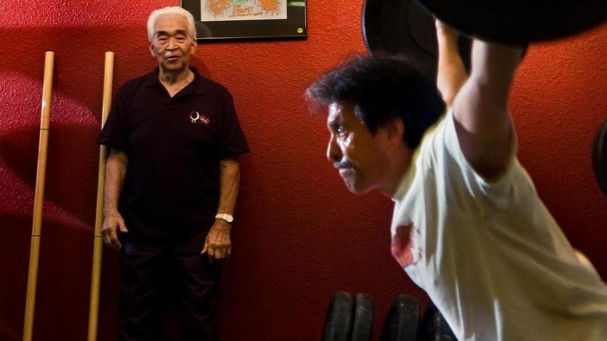 Tommy Kono coaches powerlifter Ed Pierini of Sacramento at Bodytribe Fitness in Sacramento in 2008. The two-time Olympic gold medalist and Sacramento native died Sunday, April 24, 2016, in Honolulu at age 85.