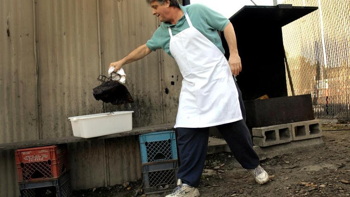 Jamie Bunnell owner of Jamie's Bar and Grill on Broadway, died Friday, April 21, 2017. In this file photo, Bunnell pulls brisket out of the smoker to serve for dinner on Wednesday, December 20, 2006.
