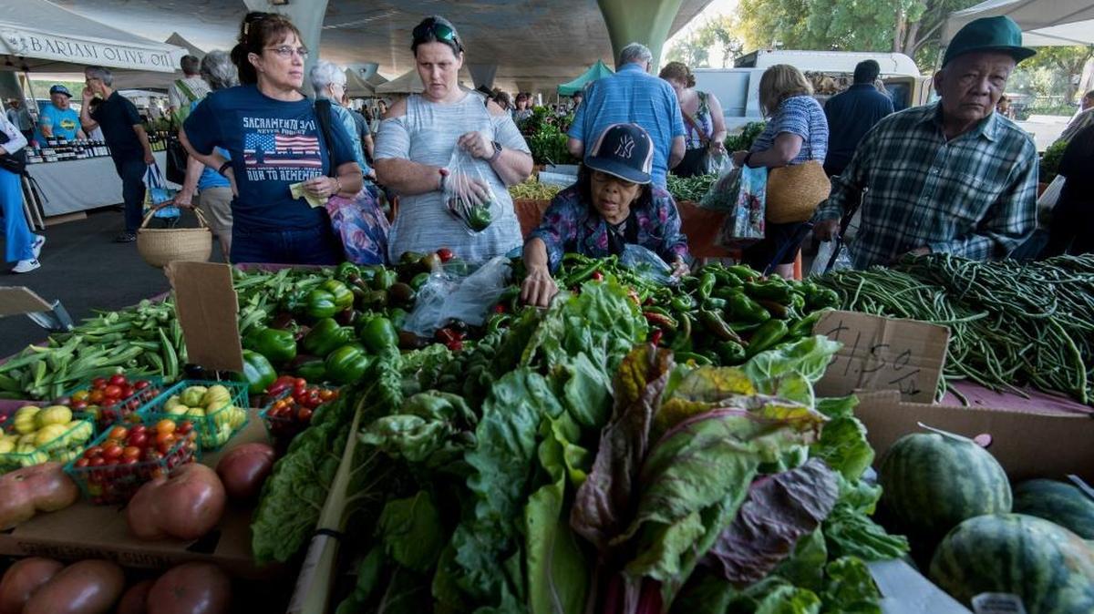 People shop for fresh produce during the Sacramento farmers market under Highway 50 in September 2017. Sunset Magazine touts the city’s numerous farmers markets and farm-to-table restaurants in ranking Sacramento tops in its list of “20 Game-Changing Places to Live” in Northern California.