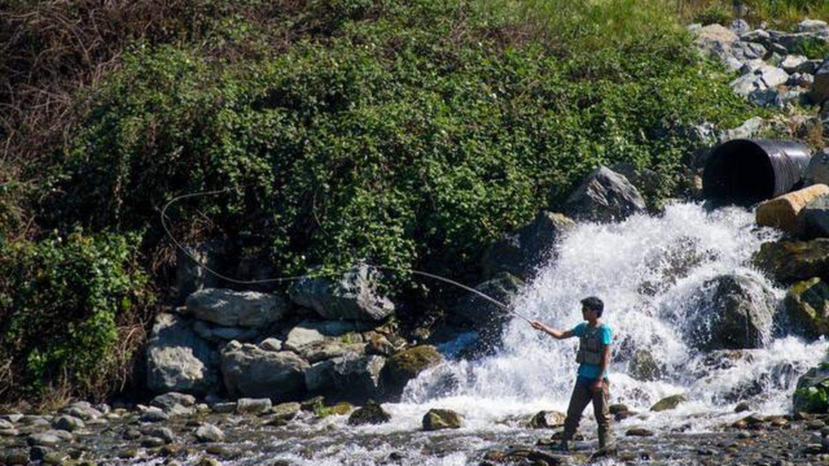 A man fishes in the American River at Sailor Bar on March 27, 2015, in Fair Oaks. Unseasonably warm March temperatures are drawing people to the rivers for recreation.