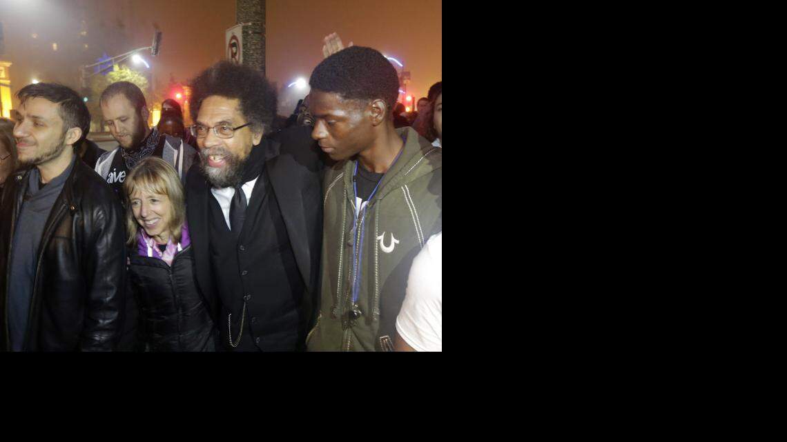 
Cornel West, center, was arrested in Ferguson, Mo., on Oct. 13, 2014.
