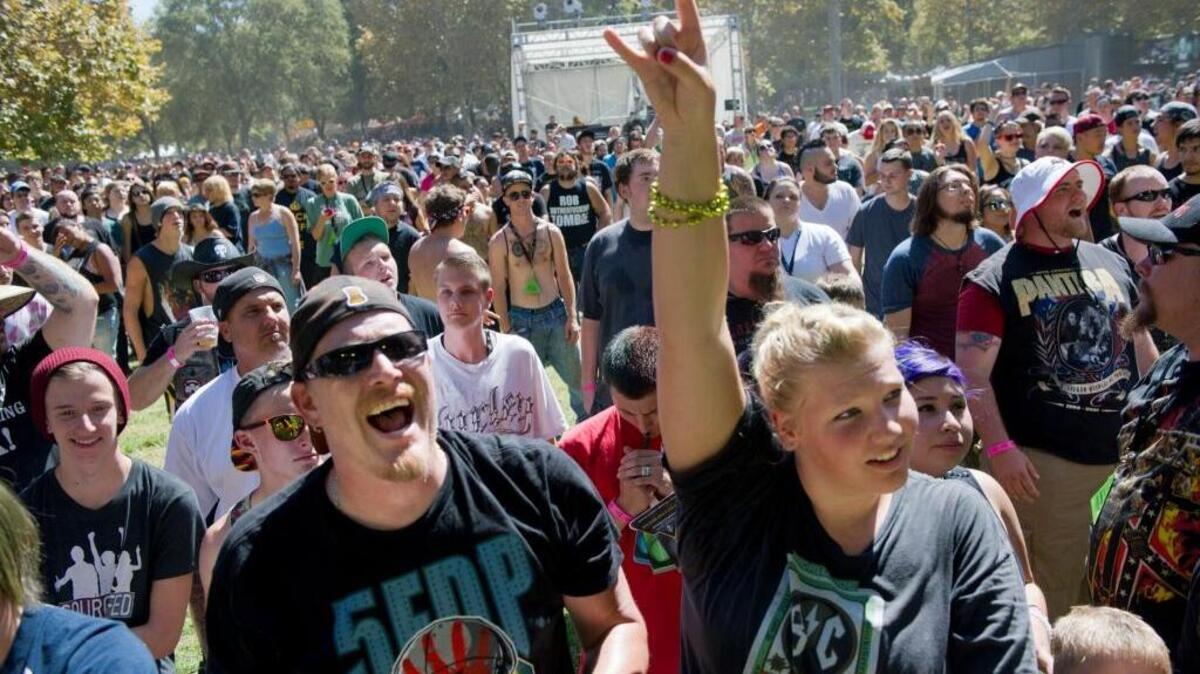 Father and daughter Miranda and Josh Guess of Sacramento rock out to the music of Anti-Mortem from Oklahoma during the Aftershock festival in 2014 at Discovery Park.