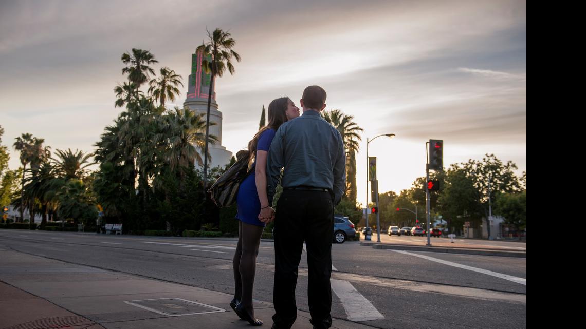 
Rae Vander-Werf kisses David Hildebrand on the cheek as they wait for the light to change at 16th Street and Broadway in Sacramento across from the Tower Theater. Built in the 1930s and still a beacon, Tower Cafe and an eclectic row of international restaurants draw crowds from nearby Southside Park, midtown, Land Park and Curtis Park, and beyond. 
