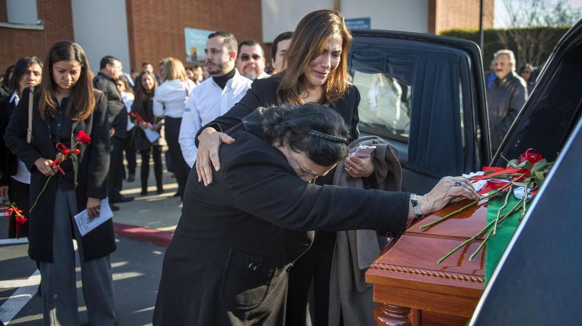 Sylvia García Williams comforts a friend at St. Ignatius Loyola Parish in Sacramento on Thursday as they place roses on the casket of her sister Alejandra García Williams, consul general of Mexico, who died Monday. She was celebrated for immersing herself in the capital’s Latino community.