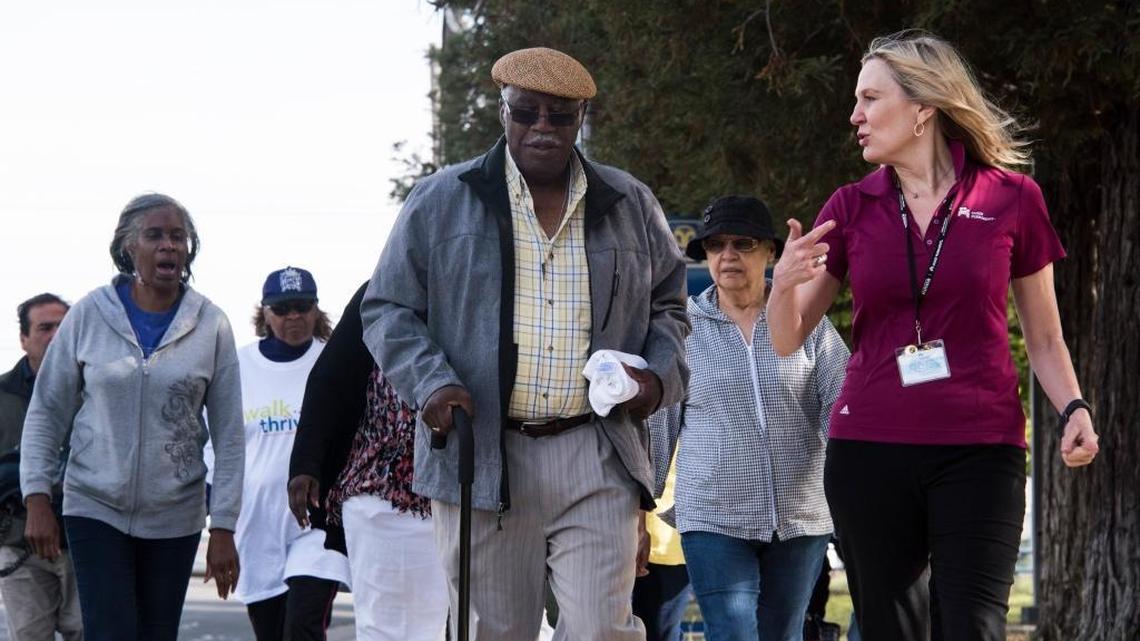 Charles Mays walks with South Sacramento Kaiser employee Eileen Peterson during the hospital's first community walk on Wednesday, June 15, 2016, in Sacramento, Calif.