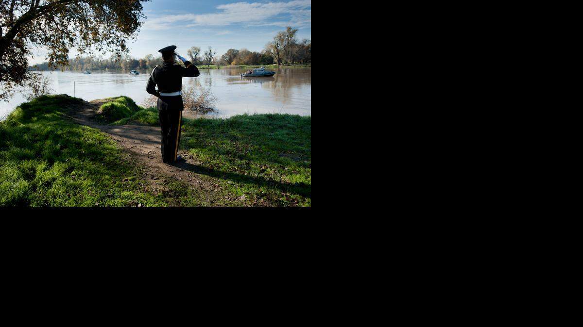 
Bugler Baldwin Wong salutes as a wreath is lain into the Sacramento River during a Pearl Harbor remembrance ceremony at Discovery Park in Sacramento on Friday, December 7, 2012. 
