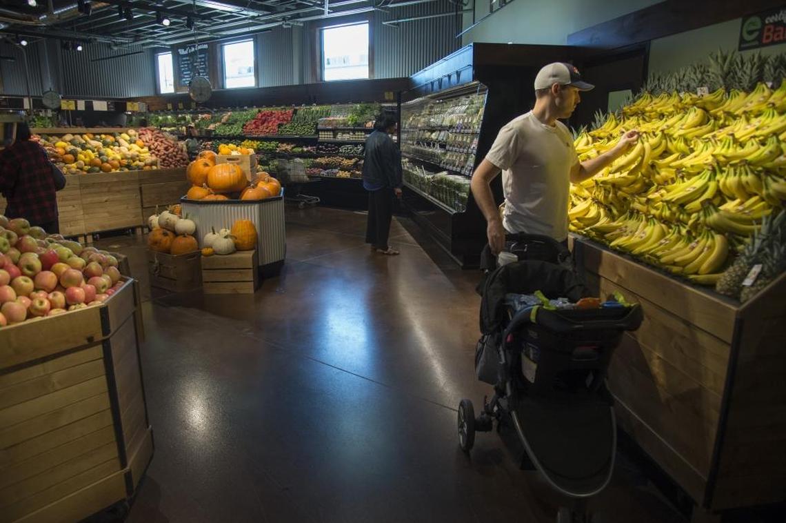 Zach Clevenger buys produce at the Sacramento Natural Foods Co-Op’s new location at 29th and R streets.