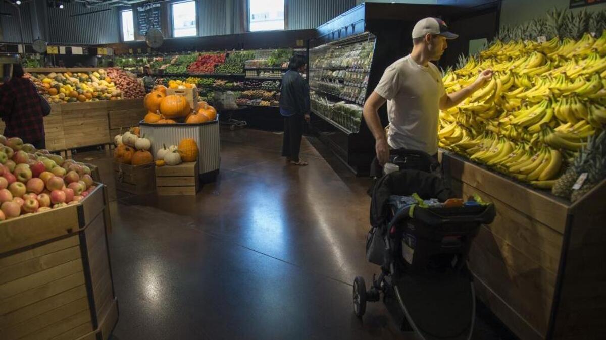 Zach Clevenger buys produce at the Sacramento Natural Foods Co-Op’s new location at 29th and R streets in 2016.