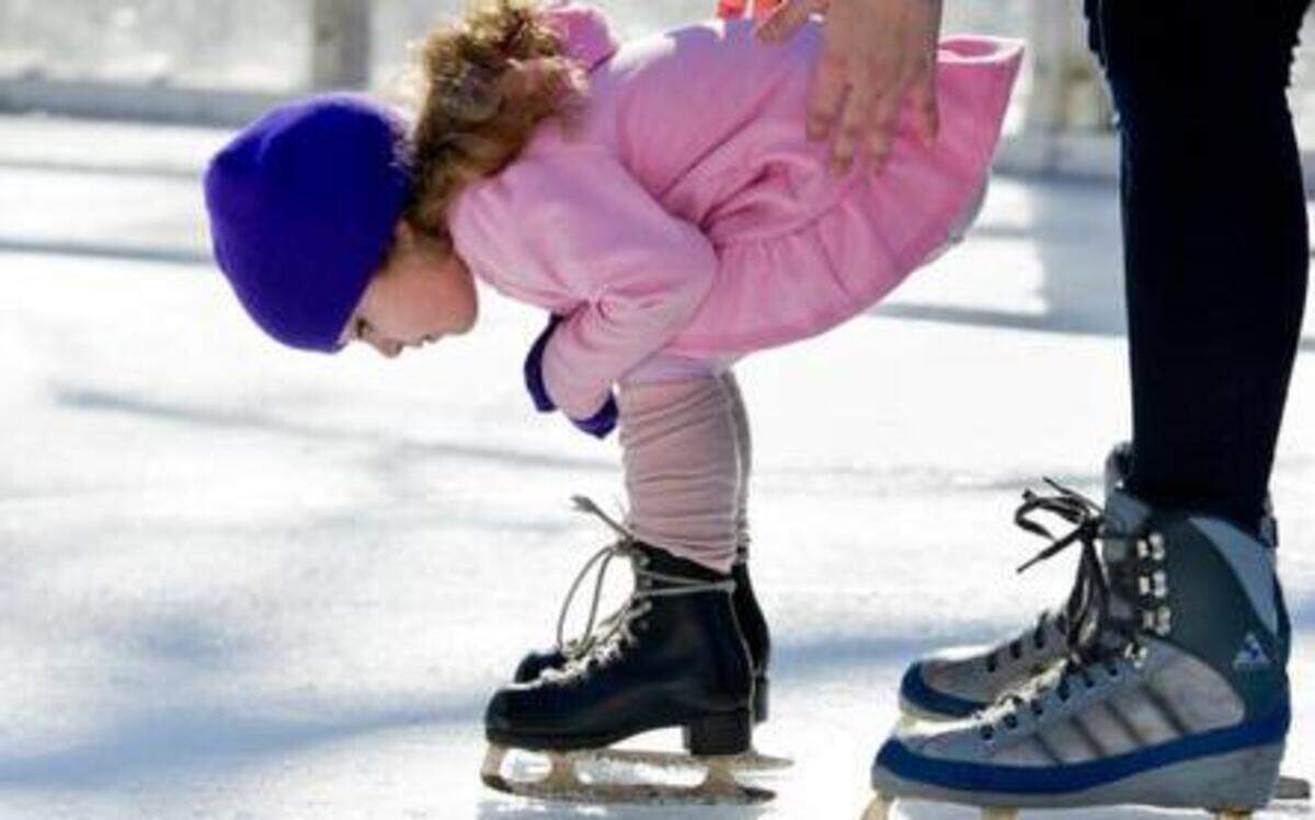 
Marilyn Barcala, 2, of Dixon, studies the ice Saturday at Sacramento’s downtown skating rink with a little support from her mother, Jillian Stevens. The same weather pattern blamed for California’s drought is now delivering chilly air.
