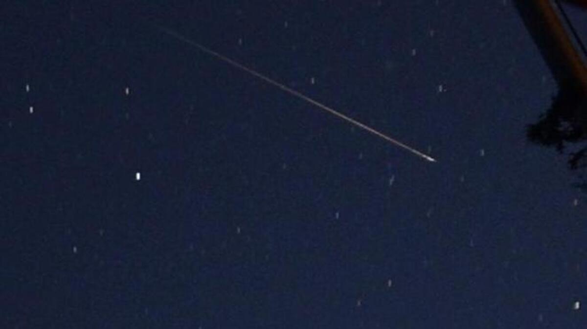 
A meteor streaks across the sky near an American flag early Wednesday, Aug. 12, 2015, in Springville, Ala. The annual Perseid meteor shower peaks Wednesday night and into Thursday morning, and dark, clear skies in the Sacramento region are expected to make good viewing conditions for the show.

