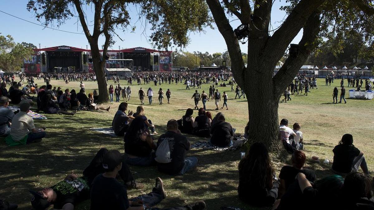 Festival fans sit in the shade during the Monster Energy Aftershock music festival at Gibson Ranch County Park on October 25, 2015.
