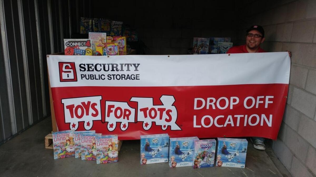 Sean Mitchell, a facility manager for Security Public Storage, displays some of the board games that were among three pallets of toys delivered by an anonymous donor for this year’s Sacramento-area Toys for Tots drive.