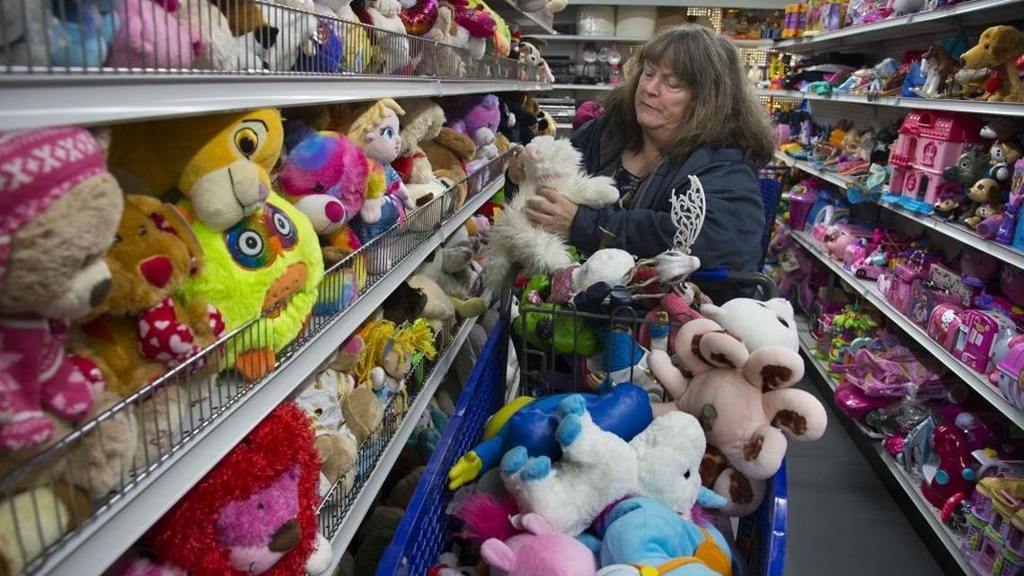 Kyle Hebbron of Citrus Heights fills a basket with stuffed animals while shopping at the Goodwill during their Grand Opening on Alhambra Blvd. in the former Sacramento Food Co-Op building.