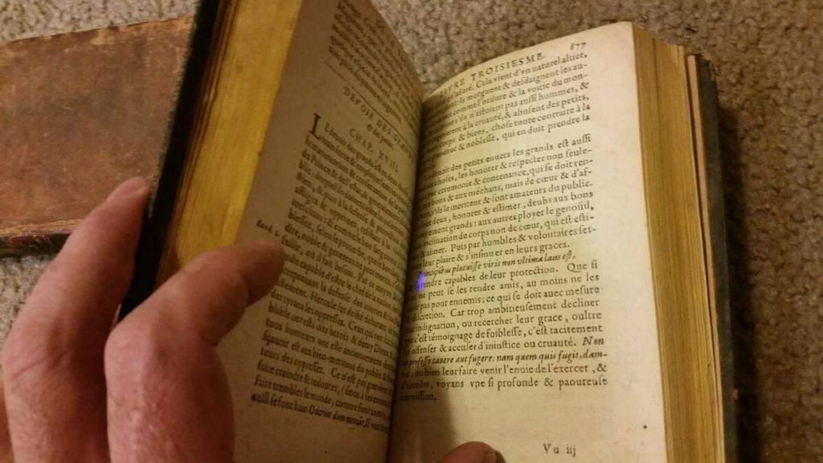 Max Brown opens one of the books he traced back to Thomas Jefferson’s personal library.