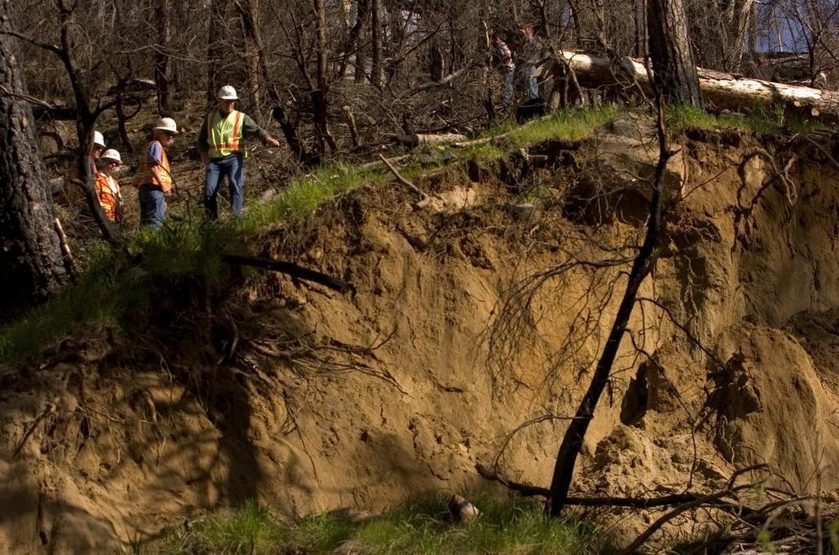 Caltrans officials evaluate a mudslide in 2006 on Highway 50 just east of Kyburz.