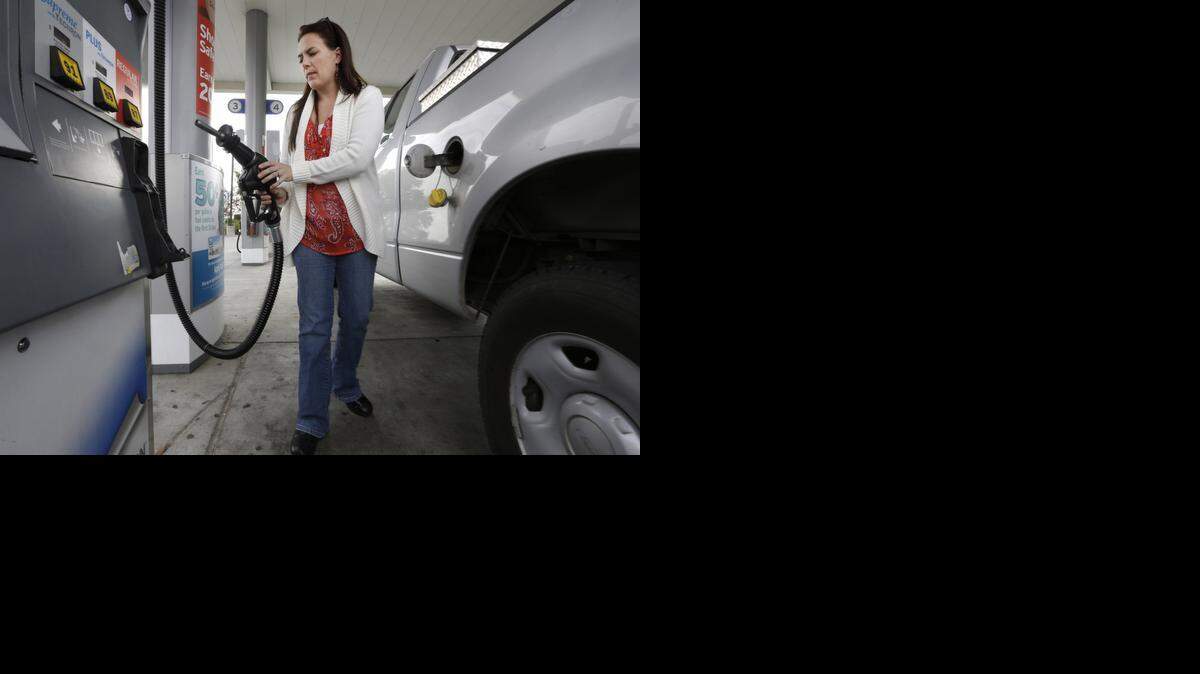 
Lydia Holland replaces the gas nozzle after filling up at a gas station in Sacramento. California lawmakers this week began another probe into the rising price of gas. The move comes as they work to advance more ambitious transportation petroleum reduction measures.
