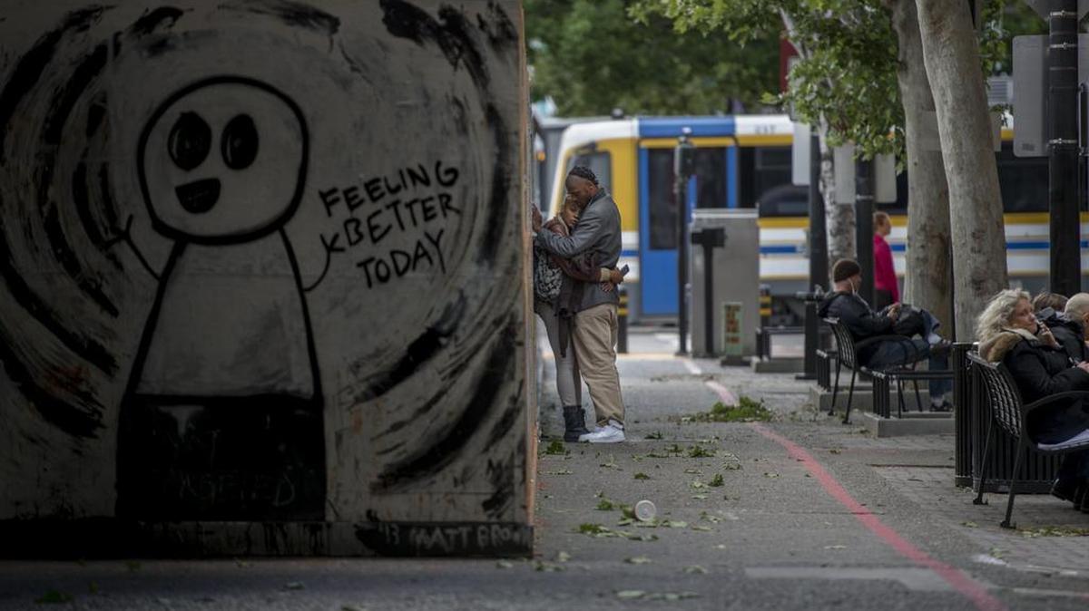 A couple waits for the Regional Transit light rail at Ninth and K streets in downtown Sacramento. Fares have increased for the first time since 2009.