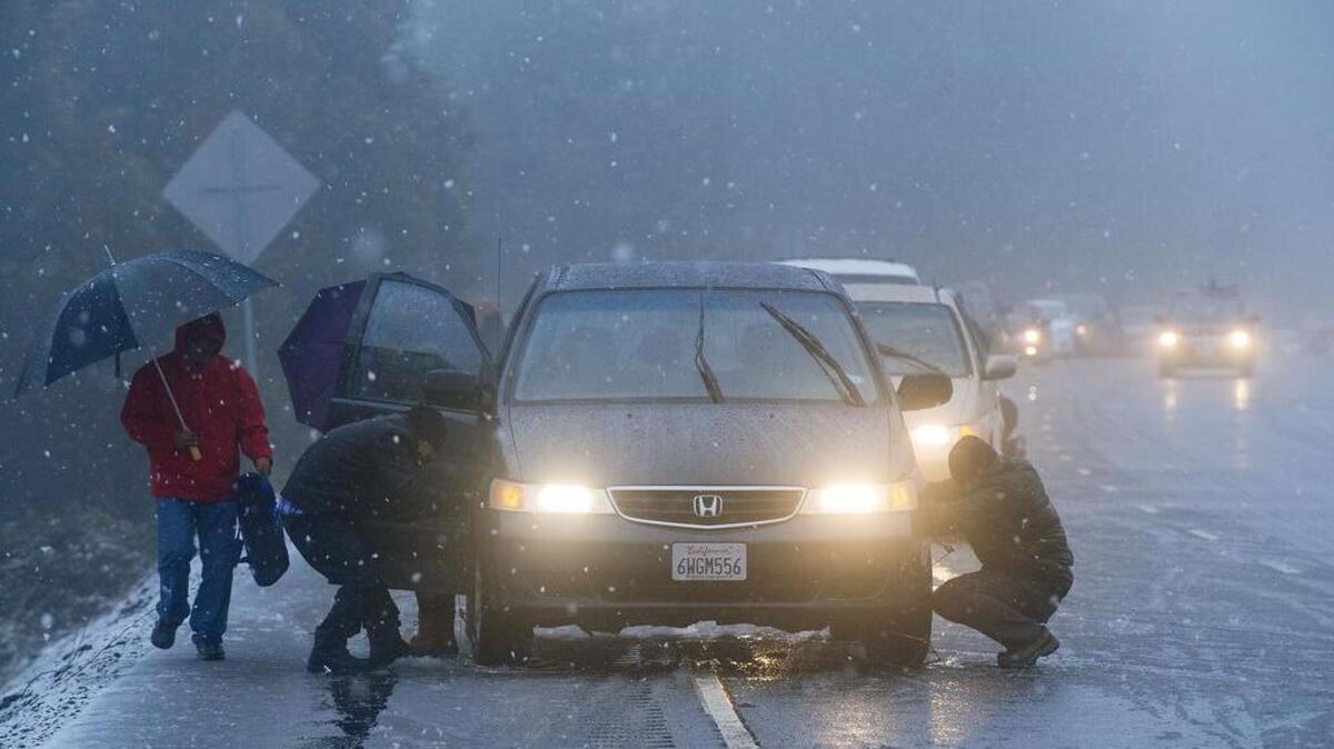 Motorists chain up their vehicles in Camino on Thursday, December 24, 2015.