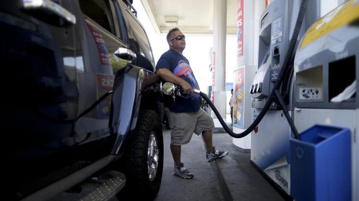 
In this June 24, 2015 photo, James Lewis fills up his Hummer as he prepares to drive to Arizona, in San Diego.
