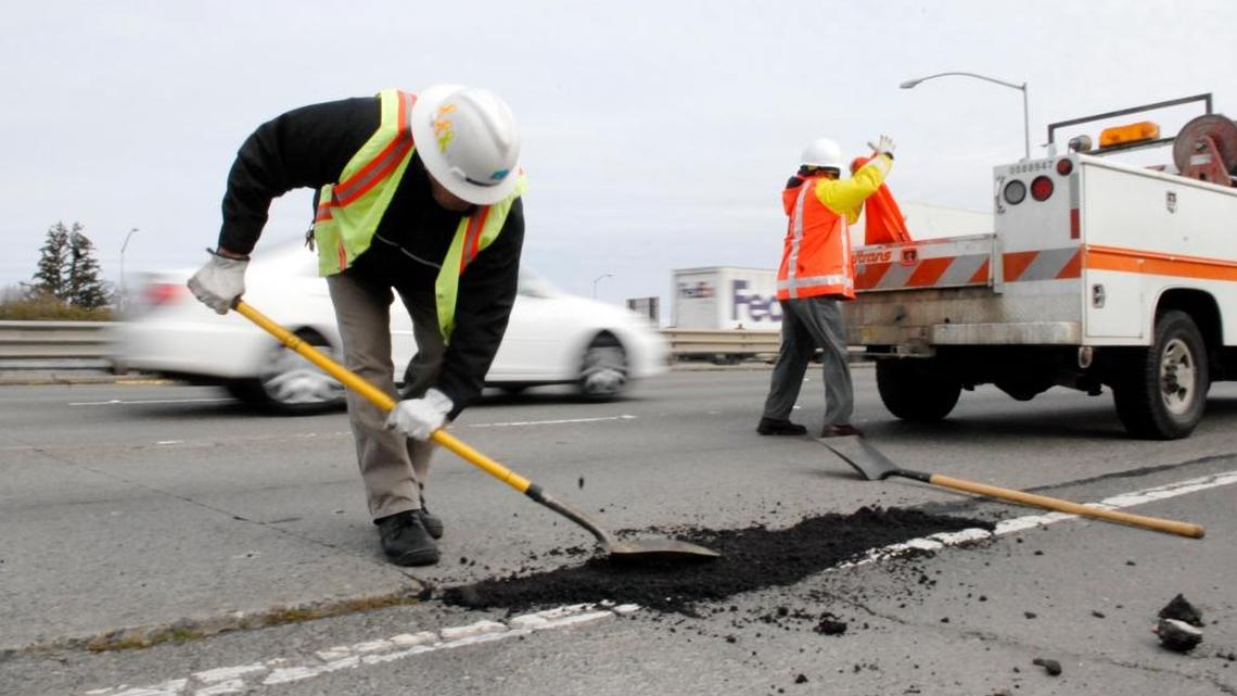 Caltrans workers fill a pothole on the Capital City Freeway. If you see a pothole developing within Sacramento County or city limits, call 311 to request a repair.