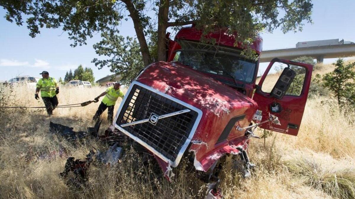 
Tow truck operators remove a big rig that plowed through several vehicles during a huge crash on westbound Interstate 80 on June 16, 2015, in West Sacramento. 
