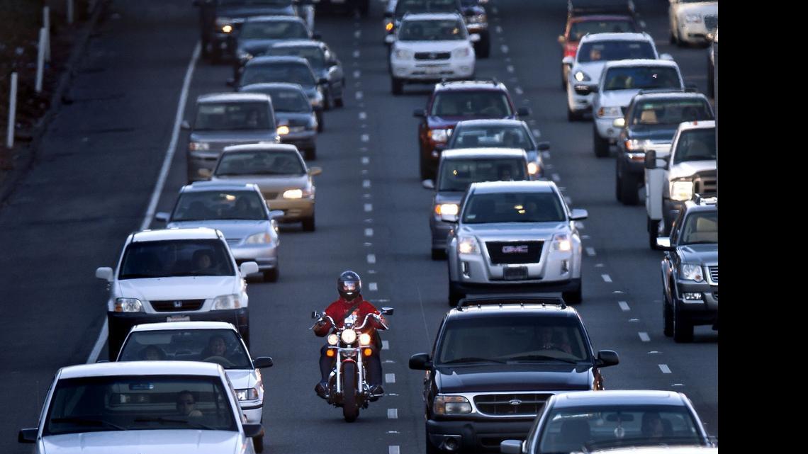 
A motorcyclist rides between the lanes during the afternoon commute on southbound Highway 99 in Sacramento. Assembly Bill 51 would put limits on the practice, which is not covered in the California Vehicle Code.
