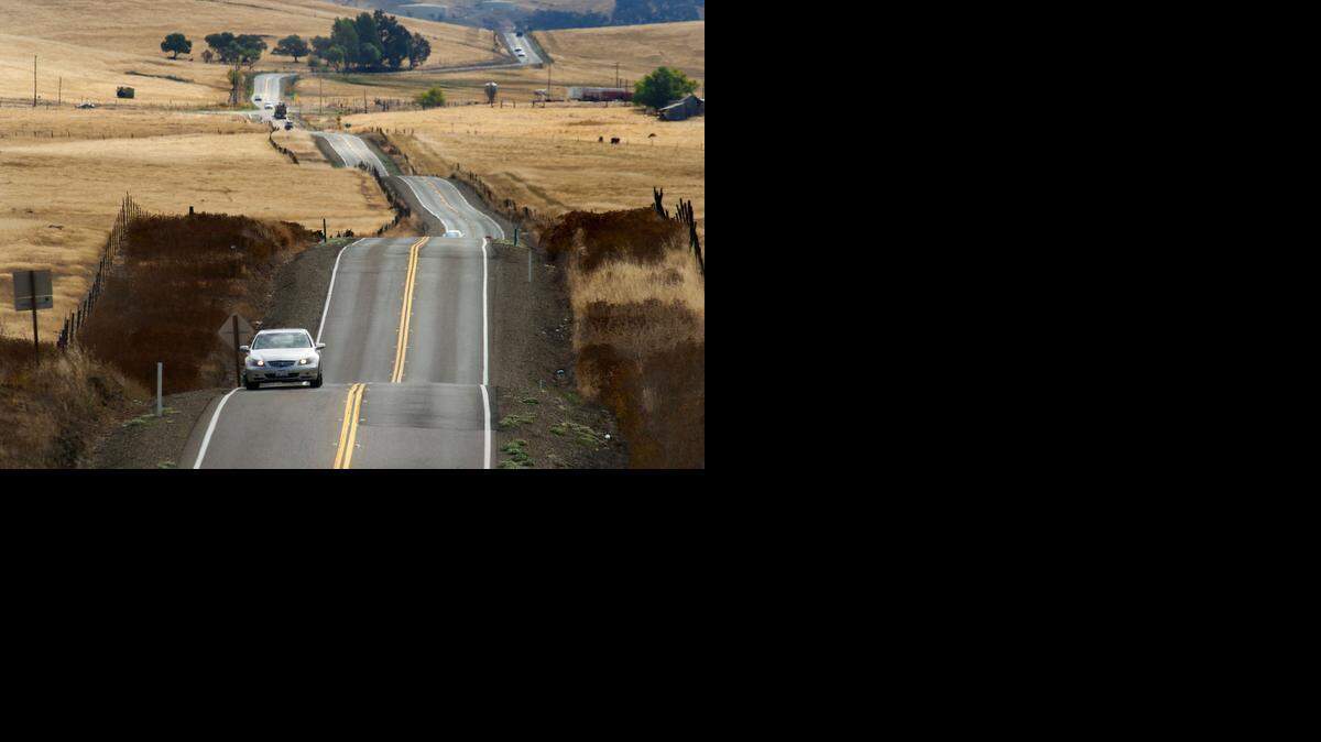 
Cars drive along White Rock Road near Scott Road in Sacramento County on Thursday, July 19, 2012.
