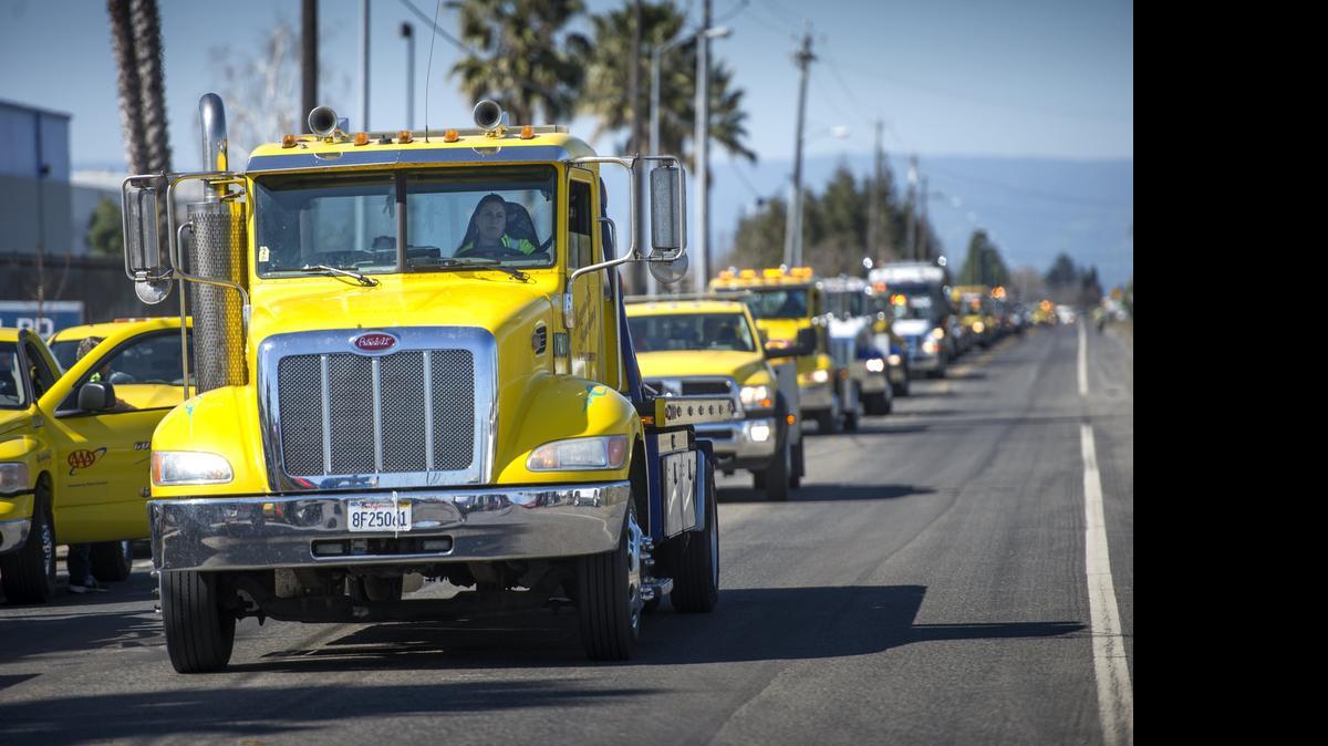
Tow trucks drive in a procession in March in memory of Michael Bower, 29, who was killed in a hit-and-run the previous month on a West Sacramento freeway ramp.
