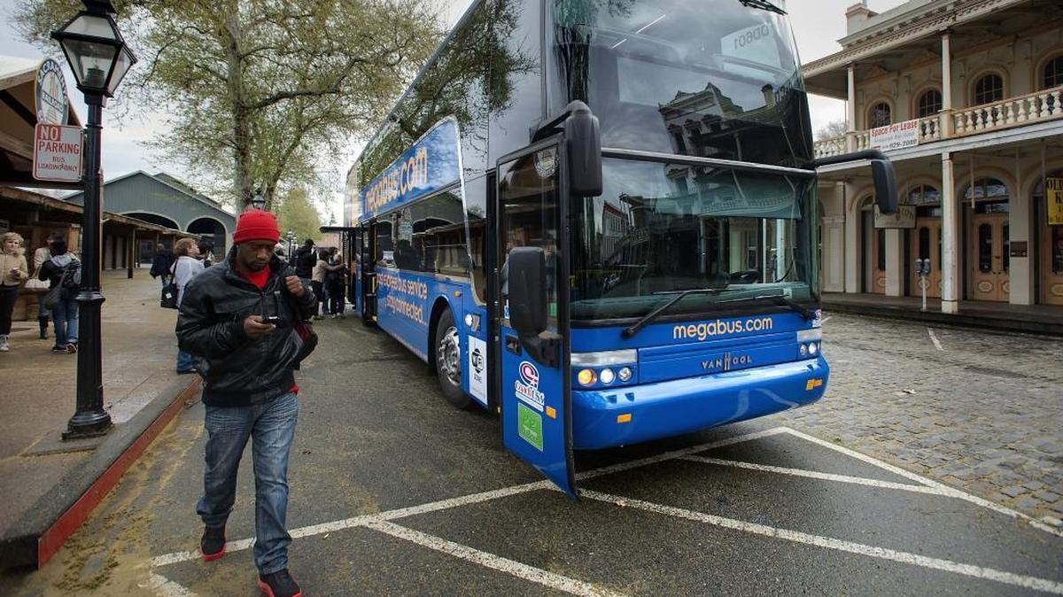 Passengers load onto the Megabus in Old Sacramento in 2013. The affordable bus line, which discontinued Sacramento service in 2018, will return to the city on May 15.