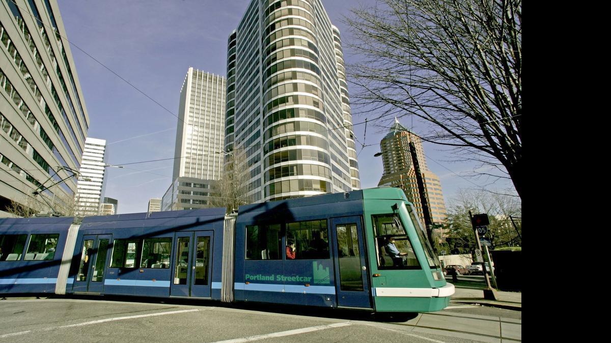 
Portland's streetcar runs through downtown on a loop of track that shares the street with cars and people. 
