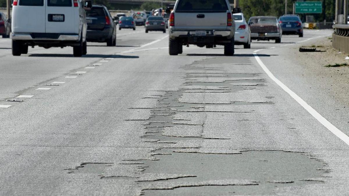 Pockmarks from peeling surface on Highway 50 over the Pioneer Bridge in Sacramento on Friday, April 21, 2017.
