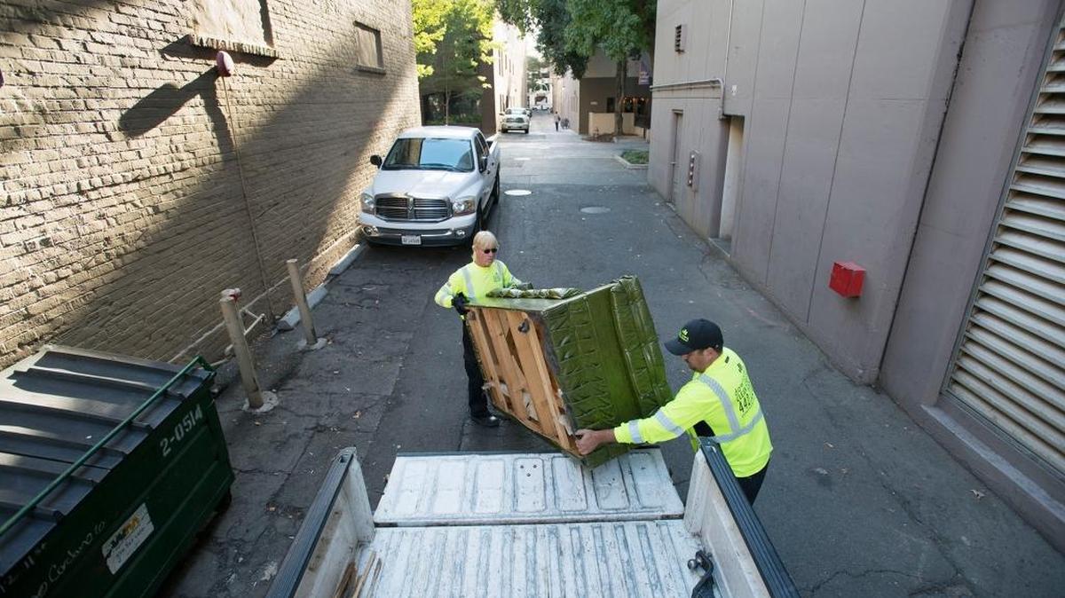 
John Trovatten, left, and Mike Kathan with the Downtown Sacramento Partnership load a discarded couch into their truck in an alley near 11th and L streets on Friday, Oct. 2, 2015. Regional Transit and the downtown partnership announced an agreement for the partnership to clean 10 downtown light-rail stations and 26 bus stops on an ongoing basis, using the same crews that have for years cleaned sidewalks, entries and alleys in the downtown core.

