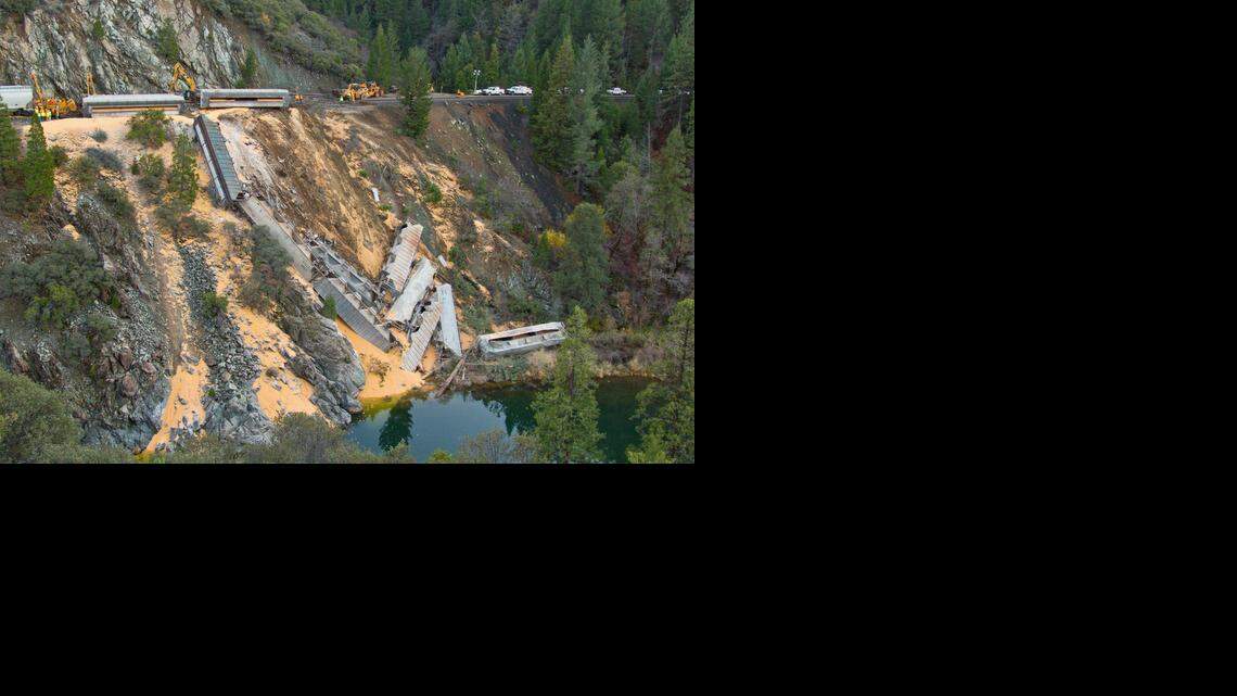 Spilled corn covers a hillside in the Feather River canyon where a derailment left Union Pacific freight cars piled like fallen dominoes.