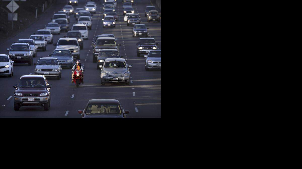 
A motorcyclist splits lanes during the afternoon commute on southbound Highway 99 in Sacramento last year. A study has found motorcyclists who adhere to the speed limit and the speed of surrounding traffic are not in greater danger while lane-splitting.
