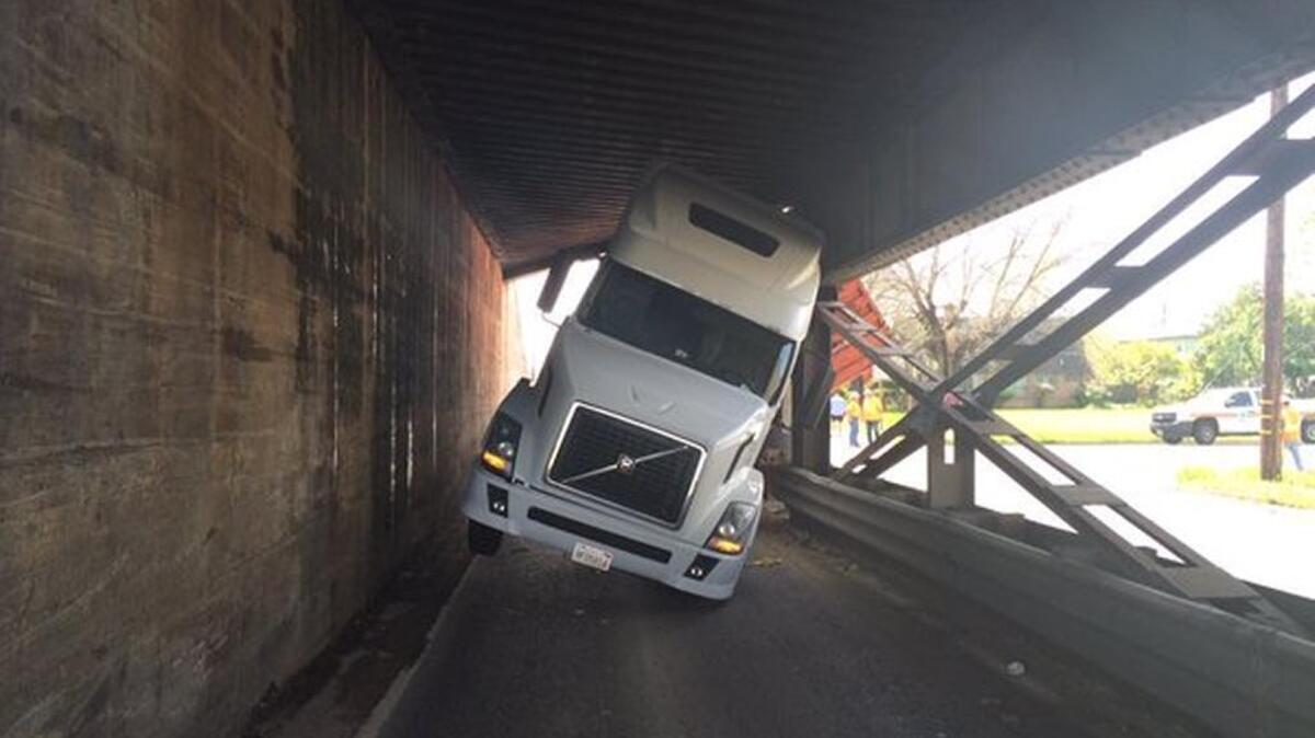 A big rig stuck beneath a train trestle prompted closure of Highway 70 near 17th Street in Marysville.