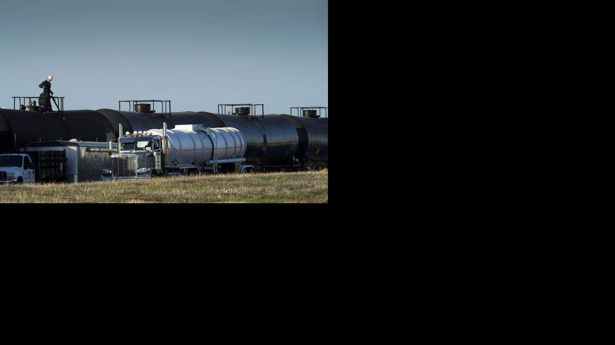 
A tanker truck is filled from railway cars containing crude oil on railroad tracks in McClellan Park in North Highlands in March.
