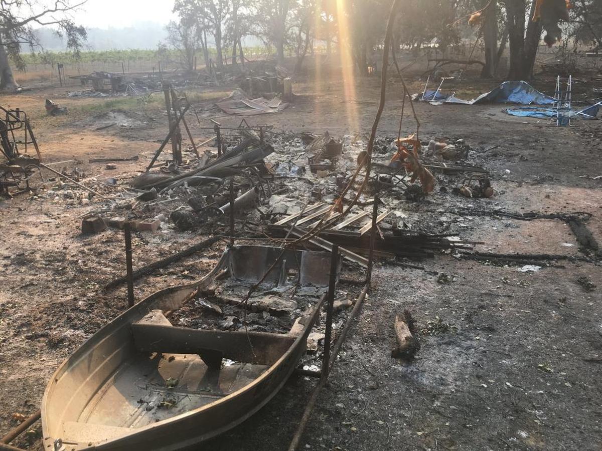 A destroyed boat sits in front of a burned home on East Road in Redwood Valley. A fast-moving wildfire tore through the rural Mendocino County town early Monday, killing at least eight people. Tuesday, Oct. 10, 2017.