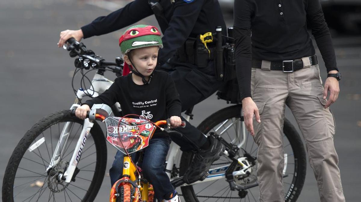 Officers from the Sacramento Police Department participate in a bike charity event in 2015. The department plans to target some cyclists and pedestrians with citations.