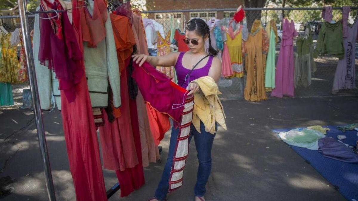 Victoria Ngo, of Sacramento, looks at some of the costumes by Sacramento Ballet at CLARA (E. Claire Raley Studios for the Performing Arts) on Saturday, Oct. 7, 2017, in Sacramento, Calif.