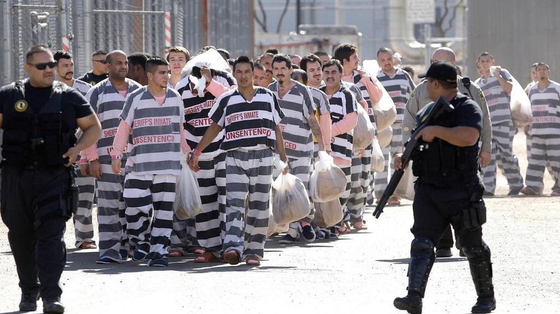 About 200 convicted illegal immigrants are handcuffed together in Phoenix and moved in 2009 into a separate area, by order of Maricopa County Sheriff Joe Arpaio, for incarceration until their sentences are served and they are deported to their home countries.