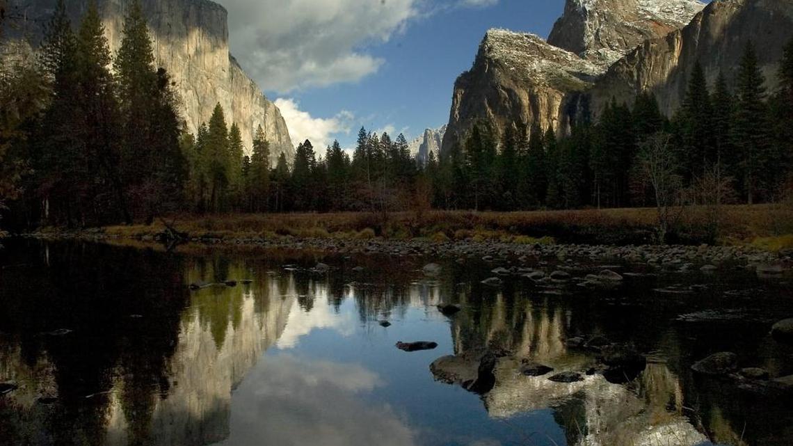 FILE - El Capitan, left, and the Cathedral Rocks, right, are reflected in the Merced River in Yosemite National Park in late November 2006.