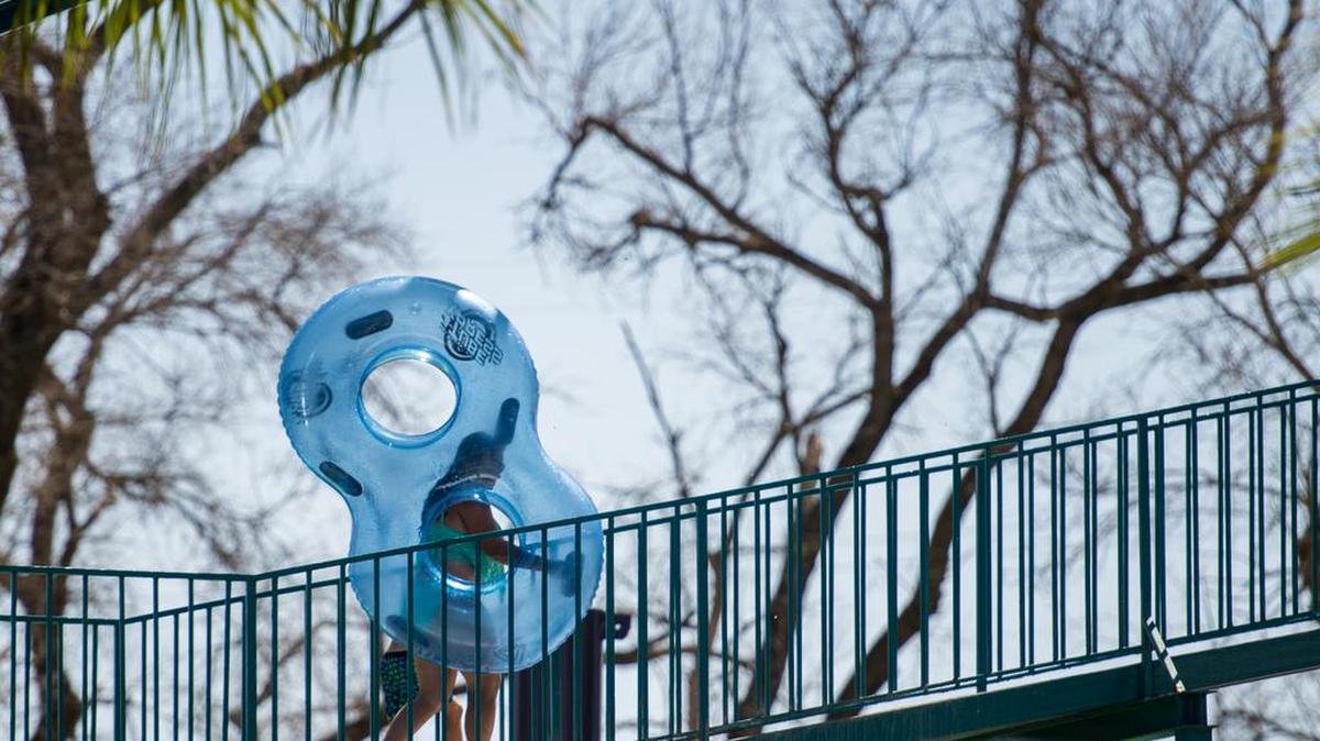 A person carries an inner tube up the “Shark Attack Waterslide Extreme” at Raging Waters Sacramento in July 2015. Palace Entertainment, which began operating Raging Waters in 2007, announced in November that it has ended its lease at Cal Expo.