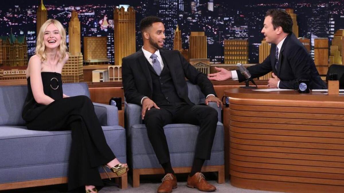 
In this image released by NBC, actress Elle Fanning, left, smiles, as host Jimmy Fallon, right, speaks with Anthony Sadler during a taping of "The Tonight Show Starring Jimmy Fallon," on Sept. 1, 2015, in New York.
